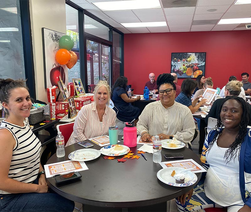 Photo of people celebrating baby shower around table
