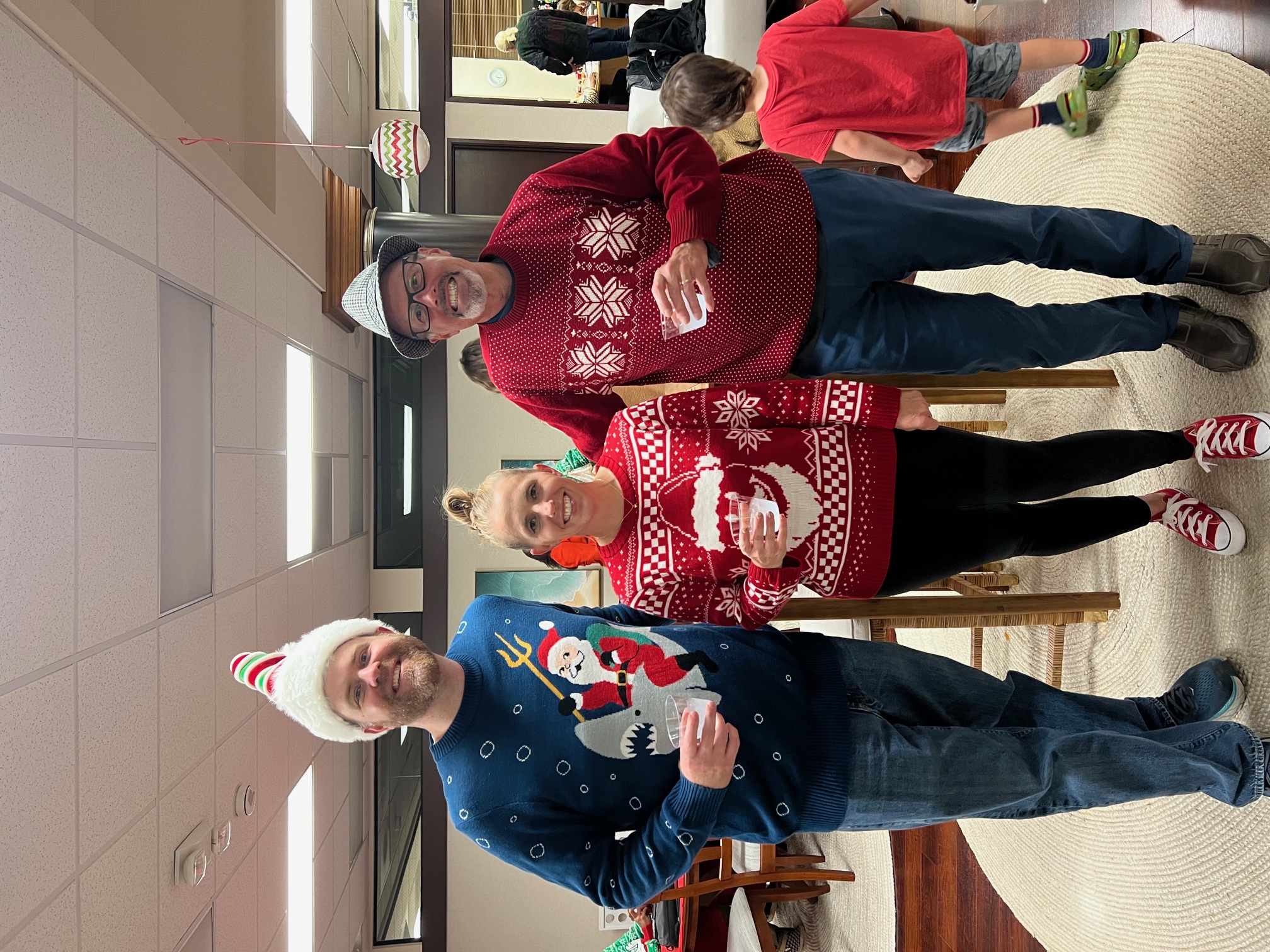 3 People Posing in Holiday Sweaters